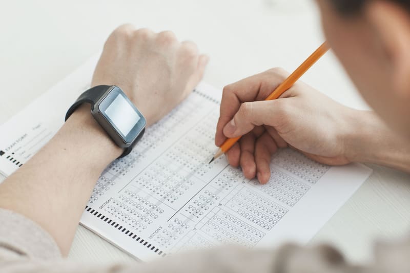Candidate timing an answer sheet during a practice test