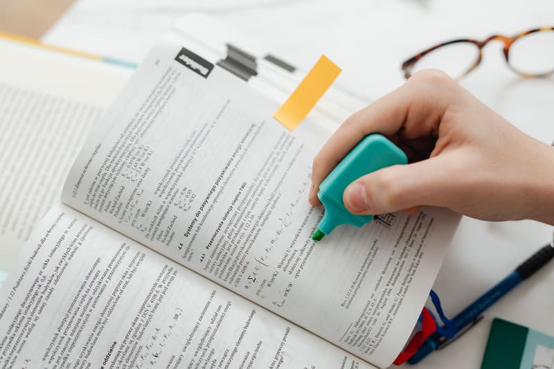 Student marking key points in a dense text